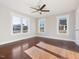 Spacious bedroom with hardwood floors, a ceiling fan, and bright windows at 624 S Eighth St, Mebane, NC 27302