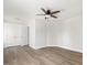 Spacious bedroom featuring wood-look flooring, neutral walls, and a ceiling fan at 624 S Eighth St, Mebane, NC 27302