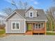 Charming gray home with a cozy front porch and a bright yellow front door at 624 S Eighth St, Mebane, NC 27302