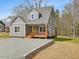 An eye-catching gray house with a charming porch, set in a serene landscape at 624 S Eighth St, Mebane, NC 27302
