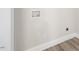 Bright laundry room with utility connections and modern wood-look flooring at 624 S Eighth St, Mebane, NC 27302