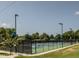 Outdoor tennis courts surrounded by trees and lighting at 624 S Eighth St, Mebane, NC 27302
