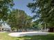 Outdoor volleyball court with lush surrounding trees and playground equipment at 624 S Eighth St, Mebane, NC 27302
