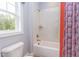Bathroom with a bathtub and shower combination, featuring hexagon tiles at 63 Rice Rd # 01, Zebulon, NC 27597