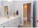 White bathroom vanity with a quartz countertop and a view into the shower at 63 Rice Rd # 01, Zebulon, NC 27597