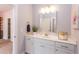 White bathroom vanity with a quartz countertop and a mirror at 63 Rice Rd # 01, Zebulon, NC 27597