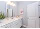 White bathroom vanity with a quartz countertop and a mirror above at 63 Rice Rd # 01, Zebulon, NC 27597
