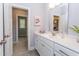 White bathroom vanity with a quartz countertop and access to another room at 63 Rice Rd # 01, Zebulon, NC 27597