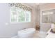 Relaxing bathroom with a large soaking tub and a walk-in shower at 63 Rice Rd # 01, Zebulon, NC 27597