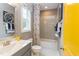 Clean bathroom with gray tile and yellow door at 63 Rice Rd # 01, Zebulon, NC 27597