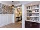 Butler's pantry with shelving, a sink, and mosaic tile backsplash at 63 Rice Rd # 01, Zebulon, NC 27597