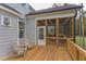 Deck with wooden flooring, access to screened porch, and two adirondack chairs at 63 Rice Rd # 01, Zebulon, NC 27597