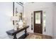 Bright entryway with dark wood door and elegant console table at 63 Rice Rd # 01, Zebulon, NC 27597