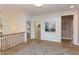 Light-filled hallway with hardwood floors and access to bedrooms at 63 Rice Rd # 01, Zebulon, NC 27597