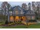Stunning two-story home with stone and siding exterior at dusk at 63 Rice Rd # 01, Zebulon, NC 27597