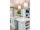 White kitchen island with quartz countertop, stainless steel sink, and dishwasher at 63 Rice Rd # 01, Zebulon, NC 27597