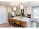 Modern kitchen with island, white cabinets, and stainless steel appliances at 63 Rice Rd # 01, Zebulon, NC 27597