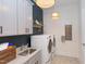 Bright laundry room with white cabinets, washer, dryer, and a utility sink at 63 Rice Rd # 01, Zebulon, NC 27597