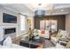 Bright living room features a fireplace, large windows, and comfortable seating at 63 Rice Rd # 01, Zebulon, NC 27597