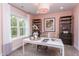 Home office with a white desk, built-in shelving, and a pink accent wall at 63 Rice Rd # 01, Zebulon, NC 27597