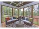 Relaxing screened porch with wicker furniture and wooded views at 63 Rice Rd # 01, Zebulon, NC 27597