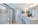 Elegant bathroom with dual sinks, quartz counters, a glass shower, and a view to the bedroom at 664 Morning Glade St, Wake Forest, NC 27587