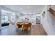 Open dining area flowing into the kitchen with seating for six and modern light fixtures at 664 Morning Glade St, Wake Forest, NC 27587
