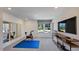 Dedicated exercise room with mirrors, equipment, and natural light at 664 Morning Glade St, Wake Forest, NC 27587