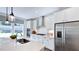 Modern kitchen featuring stainless steel appliances, white cabinetry, and quartz countertops at 664 Morning Glade St, Wake Forest, NC 27587