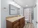 Bathroom with wood vanity, granite countertop, and floral shower curtain at 7002 Longstreet Dr # C, Raleigh, NC 27615