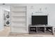 Living room with built-in shelves and large tv at 7002 Longstreet Dr # C, Raleigh, NC 27615