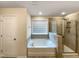 Bathroom features a large garden tub, separate shower, and a single vanity at 7434 Randshire Way, Raleigh, NC 27616