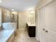 Bathroom boasts a soaking tub, separate shower, double vanity, and tiled floors at 7434 Randshire Way, Raleigh, NC 27616