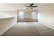 Bright bedroom with ceiling fan and neutral carpeting at 7434 Randshire Way, Raleigh, NC 27616