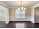 Bright dining room with hardwood floors, chandelier, and wainscoting at 7434 Randshire Way, Raleigh, NC 27616