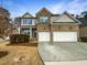 Two-story brick home with a large driveway and landscaped yard at 7434 Randshire Way, Raleigh, NC 27616