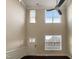 Living room with high ceilings, large windows, and hardwood floors at 7434 Randshire Way, Raleigh, NC 27616
