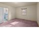 Charming bedroom with carpet, window, and access to bathroom at 809 Jeffreys Rd, Rocky Mount, NC 27804