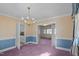Bright dining room with chandelier and access to kitchen at 809 Jeffreys Rd, Rocky Mount, NC 27804