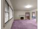 Spacious living room with fireplace and purple carpet at 809 Jeffreys Rd, Rocky Mount, NC 27804