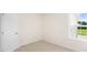 Bright bedroom with neutral walls, carpet, and large window at 8611 Brixton Shay Dr, Raleigh, NC 27616