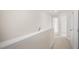 Upstairs hallway with carpeted flooring and neutral walls at 8611 Brixton Shay Dr, Raleigh, NC 27616