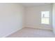 Simple bedroom with carpeted floor and a window at 104 Barn Door Dr, Lillington, NC 27546