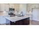Kitchen with light cabinets, large island, and stainless steel appliances at 104 Barn Door Dr, Lillington, NC 27546