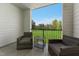 Cozy balcony with outdoor seating overlooking a green, landscaped area with a view at 107 Ailey Brook Way # 200, Wake Forest, NC 27587