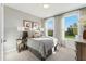 Cozy bedroom with large windows, soft natural light, and a comfortable bed with decorative pillows at 107 Ailey Brook Way # 200, Wake Forest, NC 27587