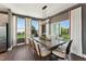 Bright dining area with modern chandelier and large windows overlooking a lush green space at 107 Ailey Brook Way # 200, Wake Forest, NC 27587
