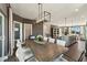 Elegant dining room with a modern chandelier, a large table, and seating for eight at 107 Ailey Brook Way # 200, Wake Forest, NC 27587