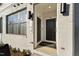 Stylish front entrance with sleek black door, sidelight, and modern light fixtures at 107 Ailey Brook Way # 200, Wake Forest, NC 27587