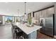 Bright kitchen with an oversized island, modern cabinetry, stainless steel appliances, and pendant lighting at 107 Ailey Brook Way # 200, Wake Forest, NC 27587